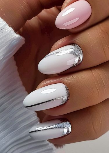 Elegant almond nail art featuring pink and white colors with intricate silver designs.