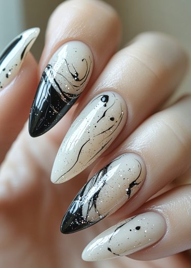 Elegant almond-shaped nude nails with black marbled designs and glitter for a stylish manicure.