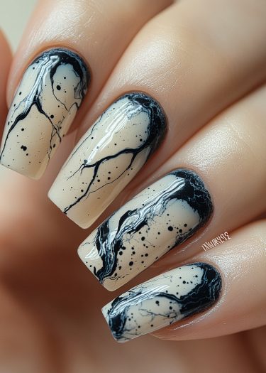 Elegant beige marble nails with black veins, showcasing sophisticated and artistic nail art design.