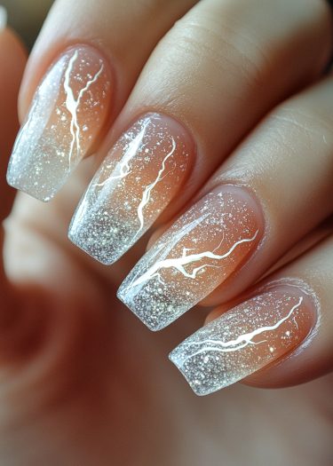 Elegant gradient nail art with lightning designs and glitter, showcasing sophisticated nail artistry.