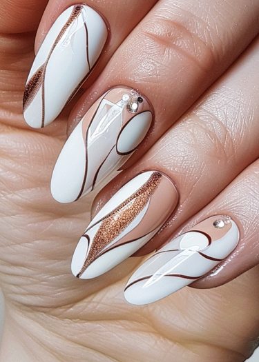 Elegant nude nails featuring copper accents and rhinestones for a sophisticated nail design.