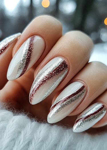 Elegant white nail art with glittery silver and red stripes for a sophisticated look.