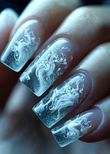 Elegant blue and white swirl nail art with intricate designs and a glossy finish.