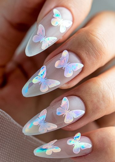 Elegant acrylic nails featuring iridescent butterfly designs, perfect for stylish nail art enthusiasts.