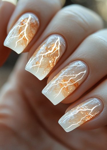 Elegant ombre nails featuring lightning bolt designs and marble patterns for stunning nail art.