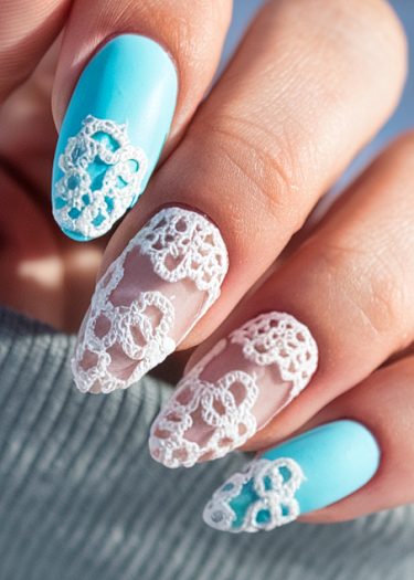 Elegant pastel blue nail art with lace designs for a sophisticated manicure look.