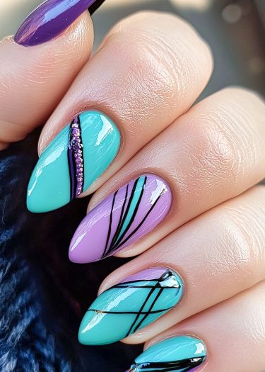 Stylish aqua and purple almond-shaped nail art with intricate designs and vibrant colors.