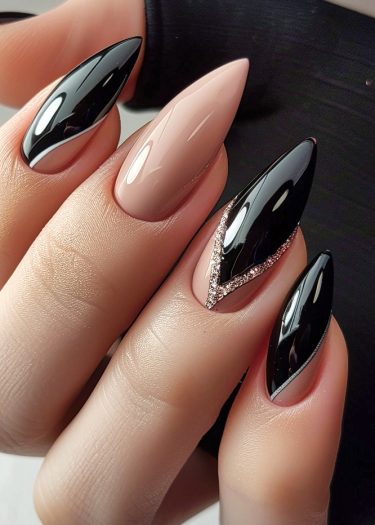 Elegant black and nude nail art with rhinestones in almond shape for stylish manicures.