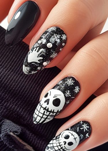 Elegant black and white Halloween nail art featuring intricate skulls and whimsical designs.