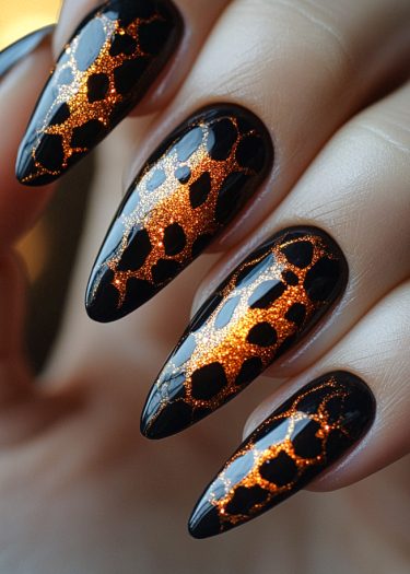 Bold black and copper animal print nail art with stiletto styling and shimmering finish.