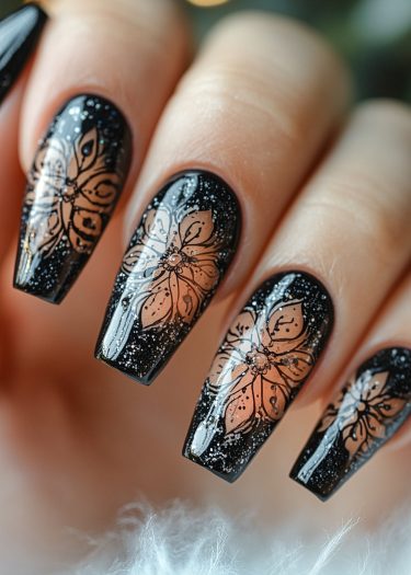 Elegant black floral manicure with sparkling accents and intricate designs for a sophisticated look.