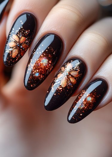 Elegant black floral nail art with gold and copper accents, perfect for fall and winter.