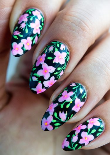 Elegant black floral nail art featuring pink flowers, perfect for stylish manicures.