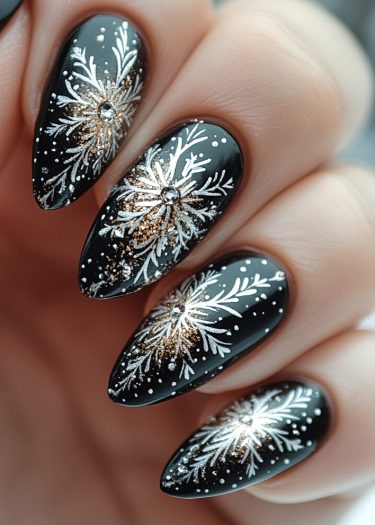 Elegant black nail design with white florals and rhinestones for a luxurious look.