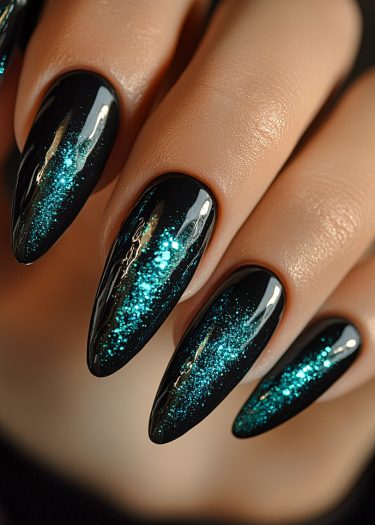 Elegant black ombre nails with turquoise glitter gradient and sharp points enhance nail art creativity.