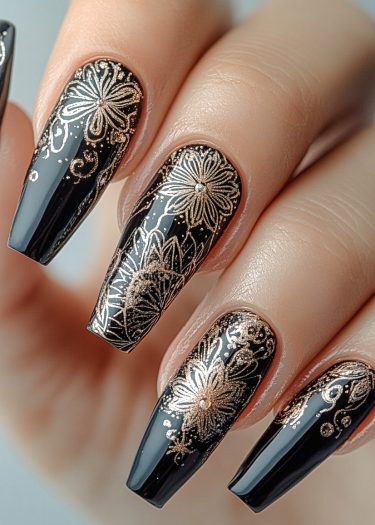 Elegant black and gold floral nail art on almond-shaped nails for a chic, sophisticated look.