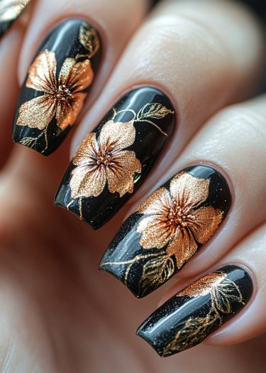 Elegant black and gold floral nail art showcasing intricate designs and high shine.