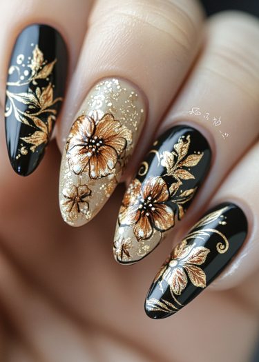 Elegant black and gold floral nail art featuring intricate designs on almond-shaped nails.