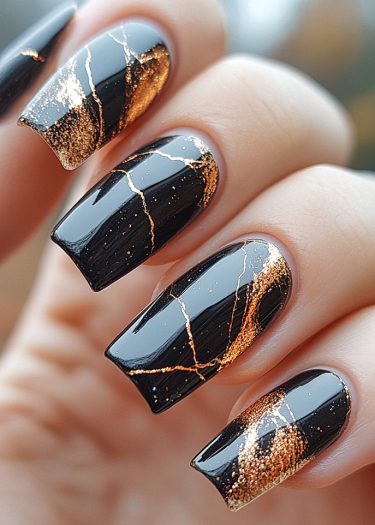 Elegant black and gold kintsugi nail art with a glossy finish and intricate designs.