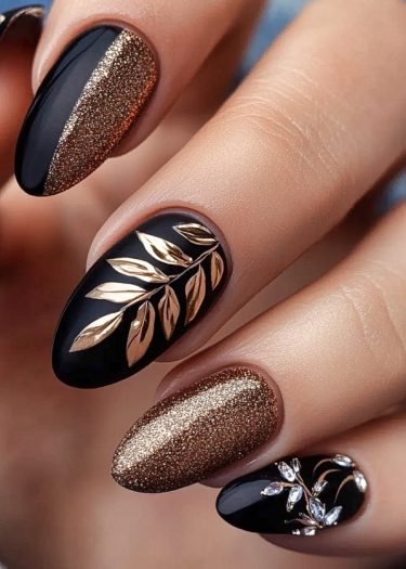 Luxurious black and gold almond-shaped nail art featuring intricate designs and glamorous details.