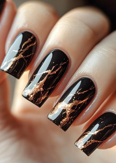 Elegant black and gold nail design with luxurious metallic accents for a sophisticated look.