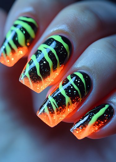 Vibrant stiletto nail art with black-orange gradient and neon yellow-green wavy lines.