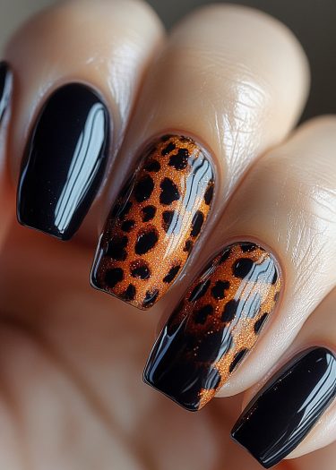 Elegant black manicure with a leopard print accent nail showcasing chic nail art design.