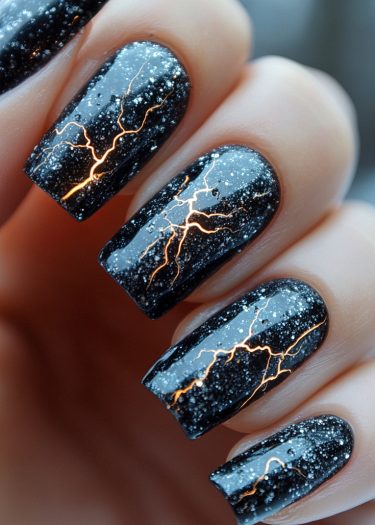 Stunning black lightning nail art with fiery orange accents and starry white details.