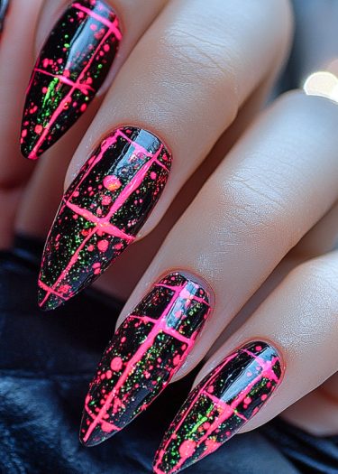 Bold black and neon pink nail art features geometric patterns and splatter design.