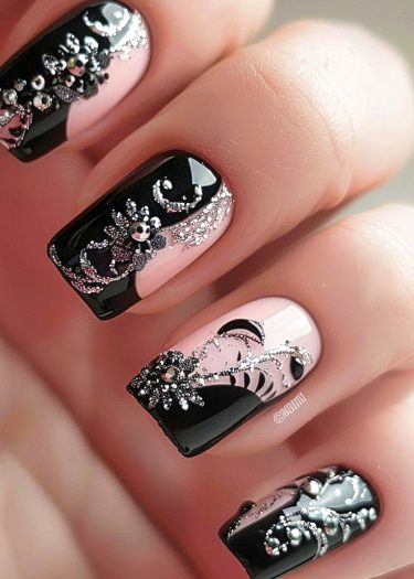 Elegant black and nude pink nail art with rhinestones and intricate designs for a luxurious look.