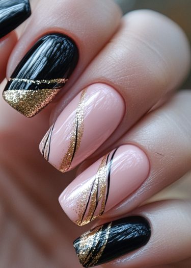 Elegant black and pink nail art with gold glitter accents for a sophisticated look.