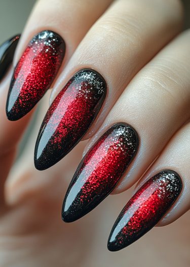 Elegant black and red gradient glitter nails with a glossy finish and almond shape.