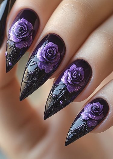 Stylish black stiletto nails adorned with vibrant purple roses and shimmering details.