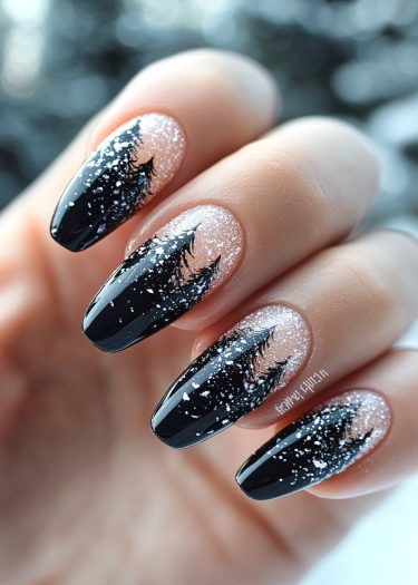 Beautiful black winter nail art featuring pine tree silhouettes and shimmering silver glitter.