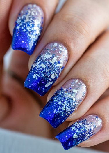 Stunning blue gradient glitter nail art design for winter elegance and glamour.