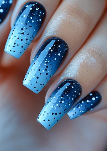 Elegant blue gradient nail art with starry patterns, perfect for any chic occasion.