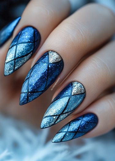 Elegant blue and silver almond-shaped nails with intricate geometric glitter design.