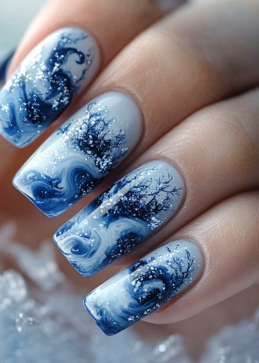 Elegant blue wave nail art with tree patterns and glitter accents for a stunning look.