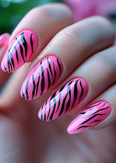 Bold pink zebra nails in a stylish design, showcasing intricate nail art and glossy finish.