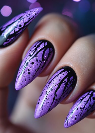 Bold purple stiletto nails with black splatter design, showcasing stunning nail art creativity.