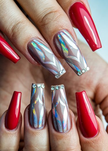 Bold red nails contrast with shimmering holographic nail art and rhinestone accents.