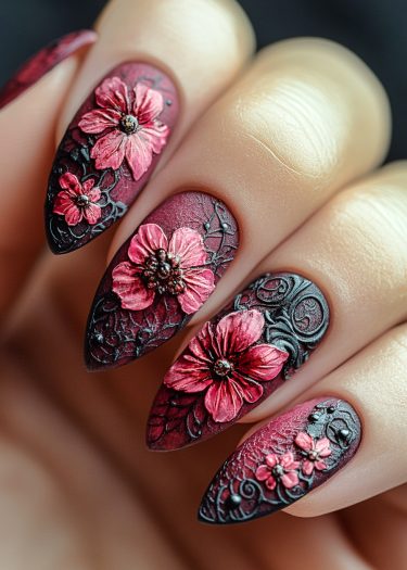 Elegant burgundy floral nail art on glossy black almond-shaped nails.