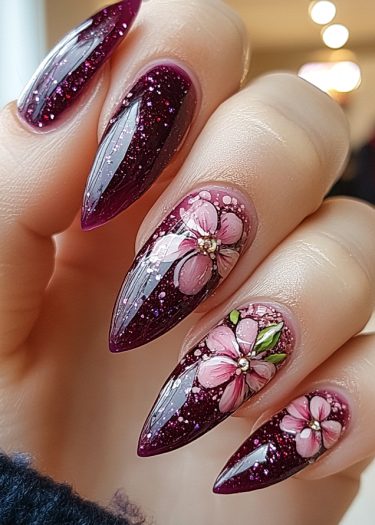 Elegant purple glam nails with floral designs and glossy finish, perfect for manicured hands.