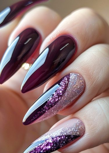 Elegant burgundy stiletto nails with sparkling glitter accents and a glossy finish.