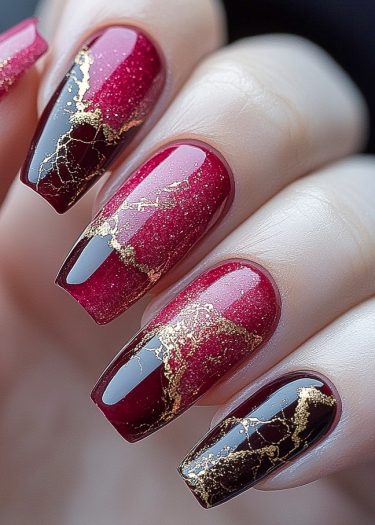 Stunning burgundy gradient nails with gold accents, perfect for elegant and trendy nail art.