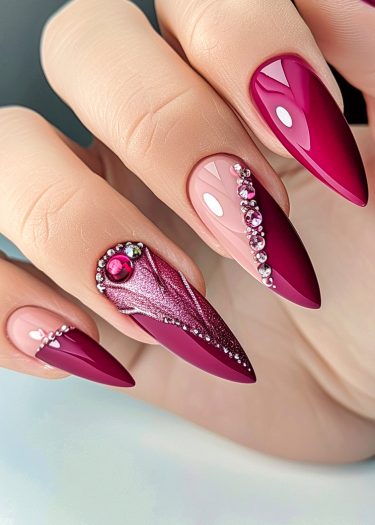 Stunning magenta and pink stiletto nails with rhinestones and glitter design.