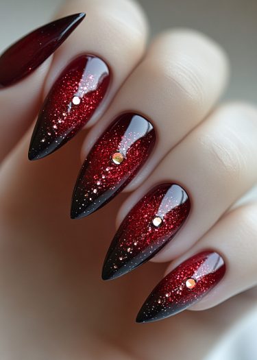 Glamorous burgundy ombre nail art featuring glitter and metallic studs for stunning elegance.