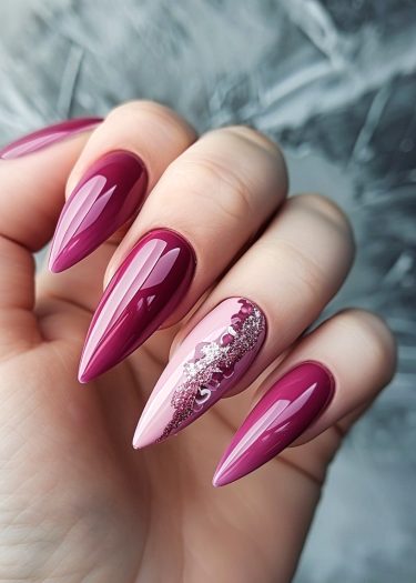 Elegant burgundy stiletto nails with intricate design and glossy finish for a sophisticated look.