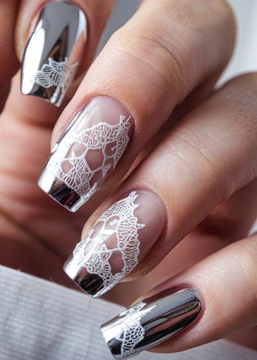 Elegant chrome and lace nail art with intricate designs and a luxurious finish.