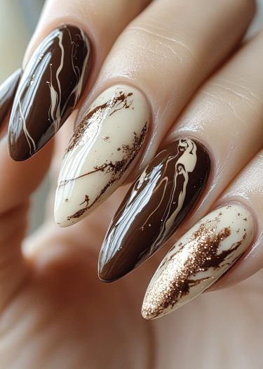 Elegant coffee-cream marble nails with rich tones and glitter accents for a sophisticated look.